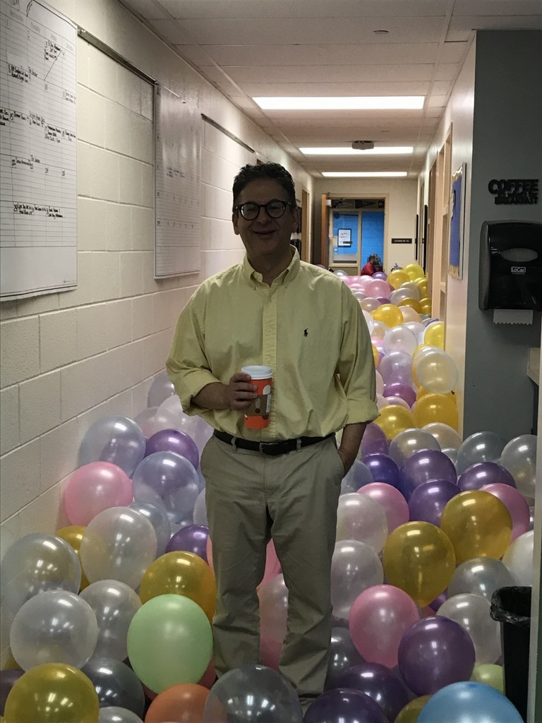 Mr. Brickman amongst balloons in the main office